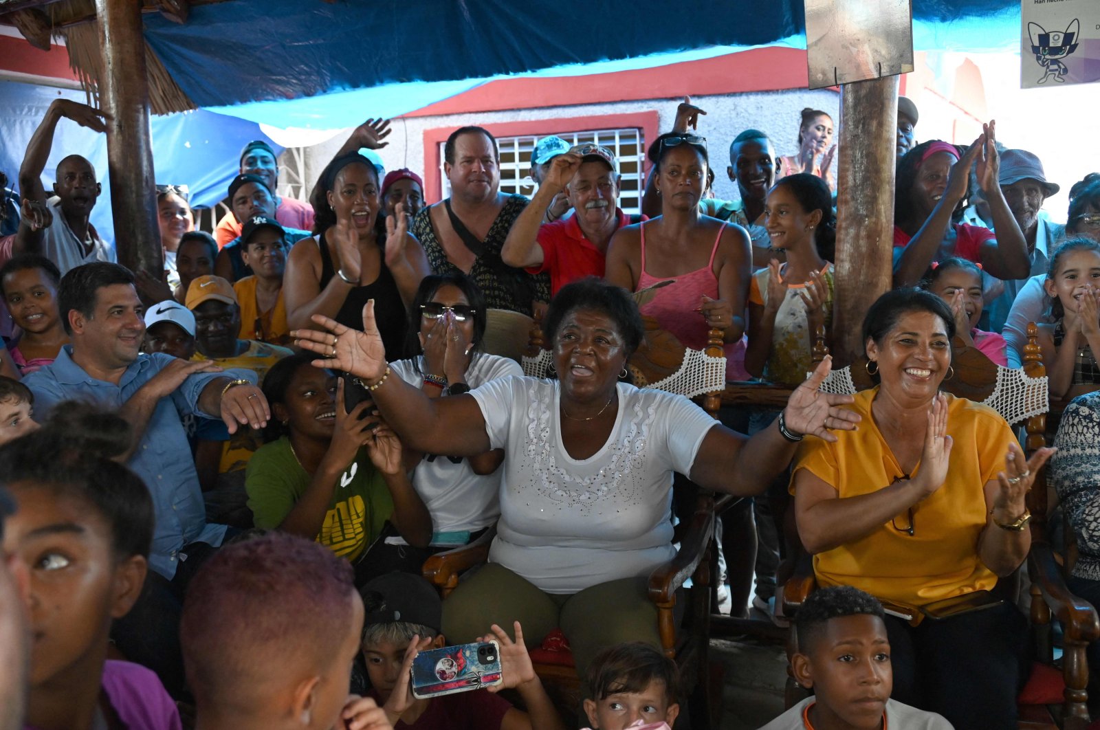 The mother of Cuban wrestler Mijain Lopez, Leonor Nunez (C), celebrates with friends and neighbours the victory of her son after he won the men&#039;s greco-roman 130 kg. wrestling event at the Paris 2024 Olympic Games, at her home in the town of Herradura, Pinar del Rio province, Cuba, Aug. 6, 2024. (AFP Photo)