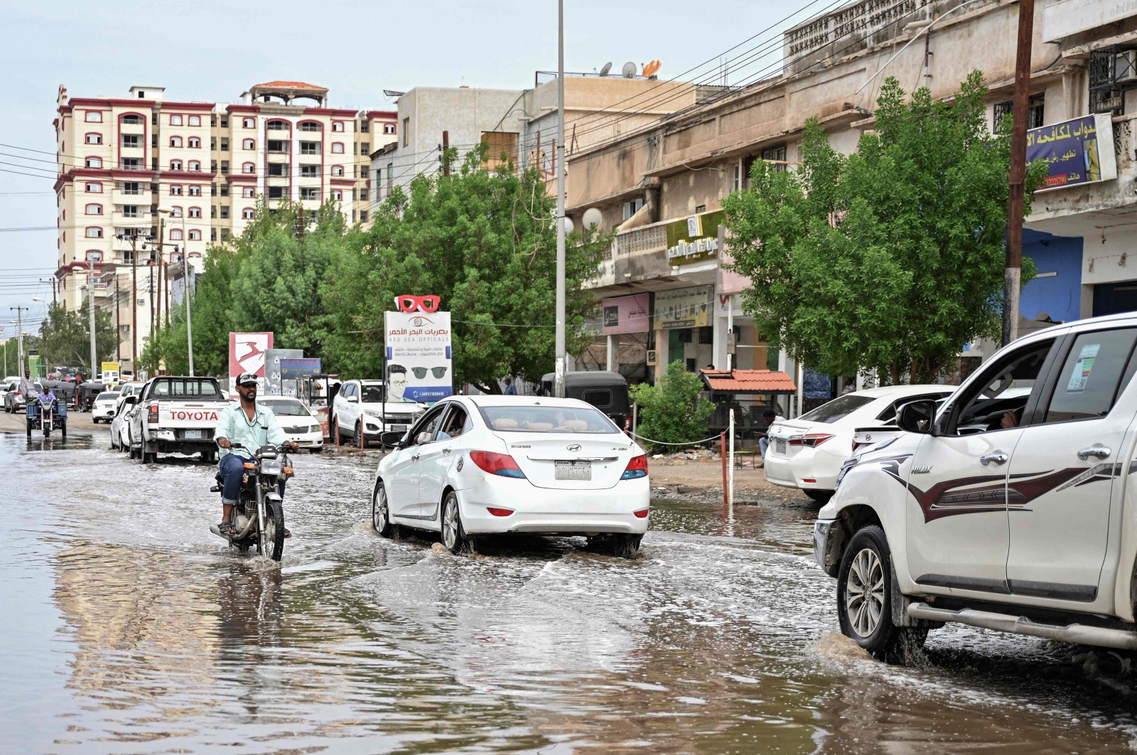 A man rides a motorcycle in an inundated street after torrential rain in Port Sudan, Sudan, Aug. 1, 2024. (AFP Photo)