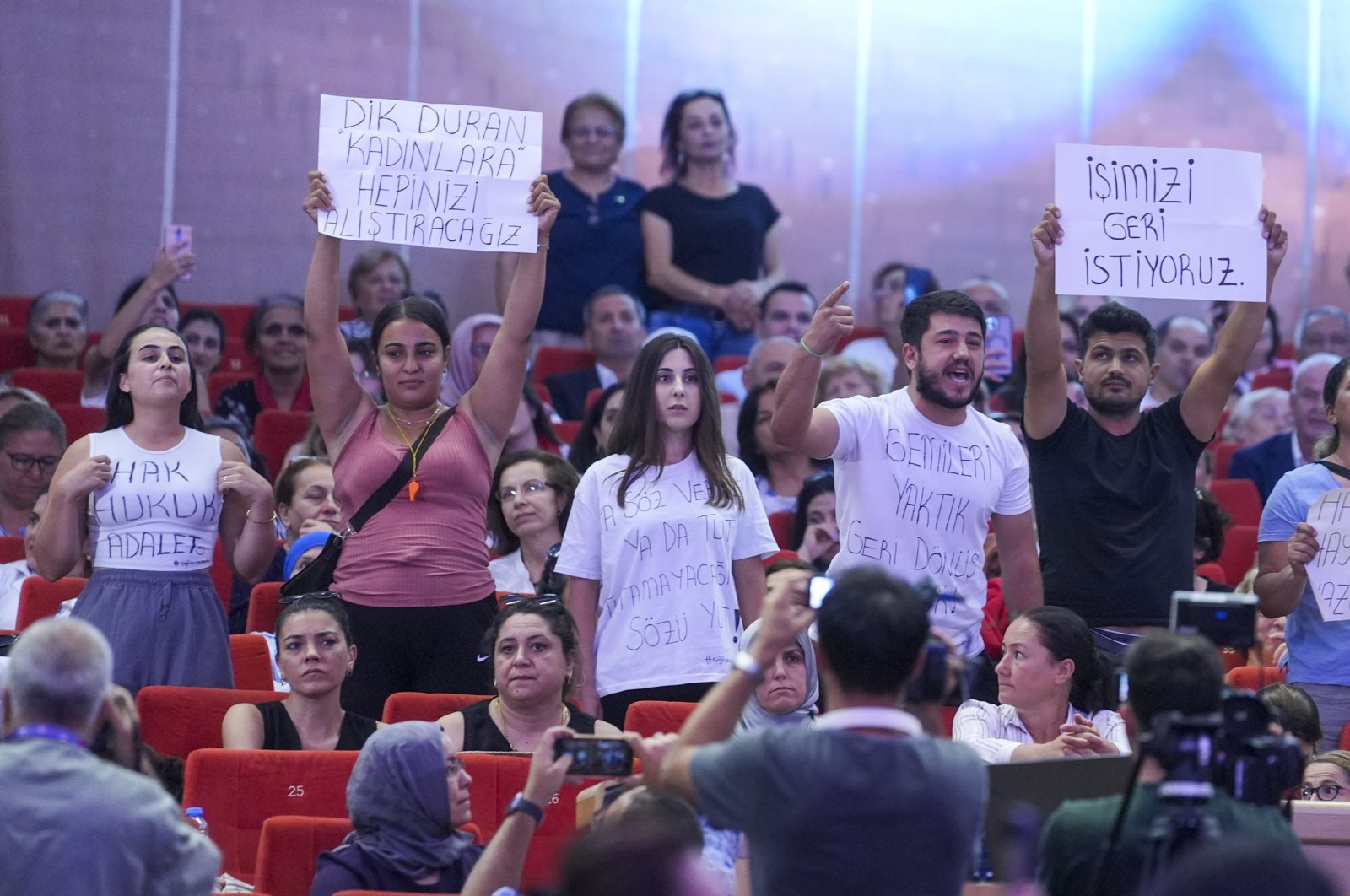 Fired workers wave placards reading &quot;we want our jobs back&quot; during an event attended by CHP leader Özgür Özel, Ankara, Türkiye, Aug. 4, 2024. (AA Photo)