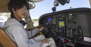 American pilot Ethan Guo poses for the photographer before his take off from Geneva Airport for attempting a world record solo flight to all seven continents, Geneva, Switzerland, Aug. 6, 2024. (AP Photo)