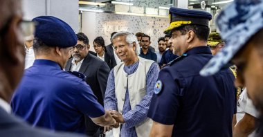 Nobel laureate Muhammad Yunus shakes hands with senior members of the Bangladesh Army, upon his arrival at the Hazrat Shahjalal International Airport in Dhaka, Aug. 8, 2024.  (AFP Photo)