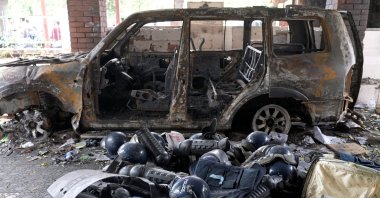 Damaged riot gear of security forces is seen next to a burnt vehicle outside a police station, days after the resignation of former Bangladeshi Prime Minister Sheikh Hasina, Dhaka, Bangladesh, Aug. 8, 2024. (Reuters Photo)