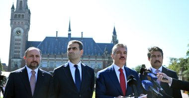Cüneyt Yüksel (R-2), head of the Turkish Parliament’s legal committee, talks to reporters after filing the declaration of intervention outside The Hague, the Netherlands, Aug. 7, 2024. (AA Photo)