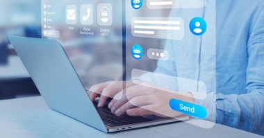 This illustration photo shows a person using online customer service with a chatbot to get support. (Reuters Photo)