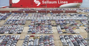 New cars wait for transportation near a Sallaum Lines ro-ro ship docked in Yantai, Shandong province, China, Aug. 6, 2024. (Chinatopix via AP)