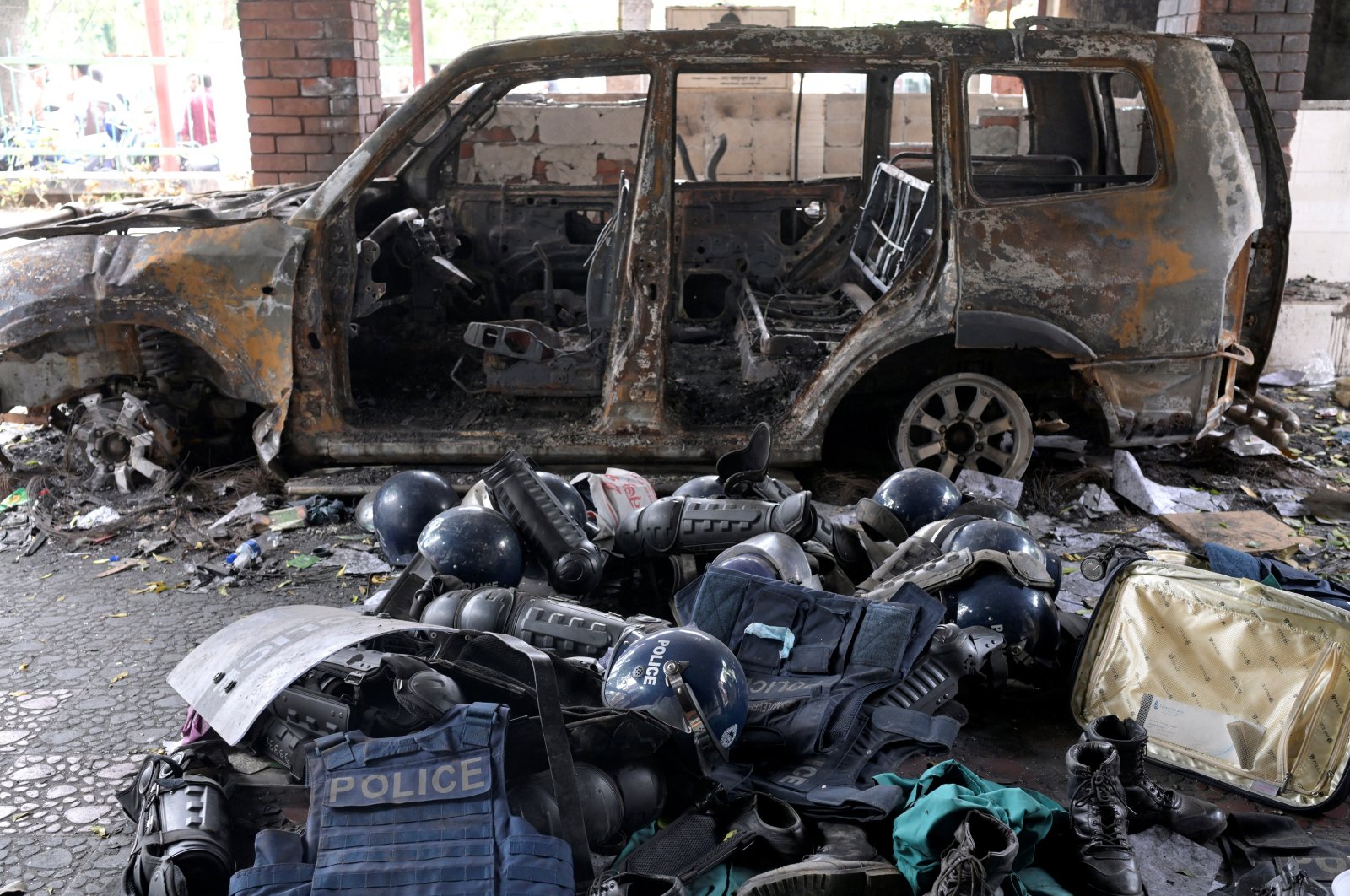 Damaged riot gear of security forces is seen next to a burnt vehicle outside a police station, days after the resignation of former Bangladeshi Prime Minister Sheikh Hasina, Dhaka, Bangladesh, Aug. 8, 2024. (Reuters Photo)