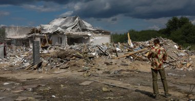 A man takes a picture of a residential building heavily damaged by a Russian missile strike, in the village of Rozhivka in Kyiv region, Ukraine, Aug. 11, 2024. (Reuters Photo)