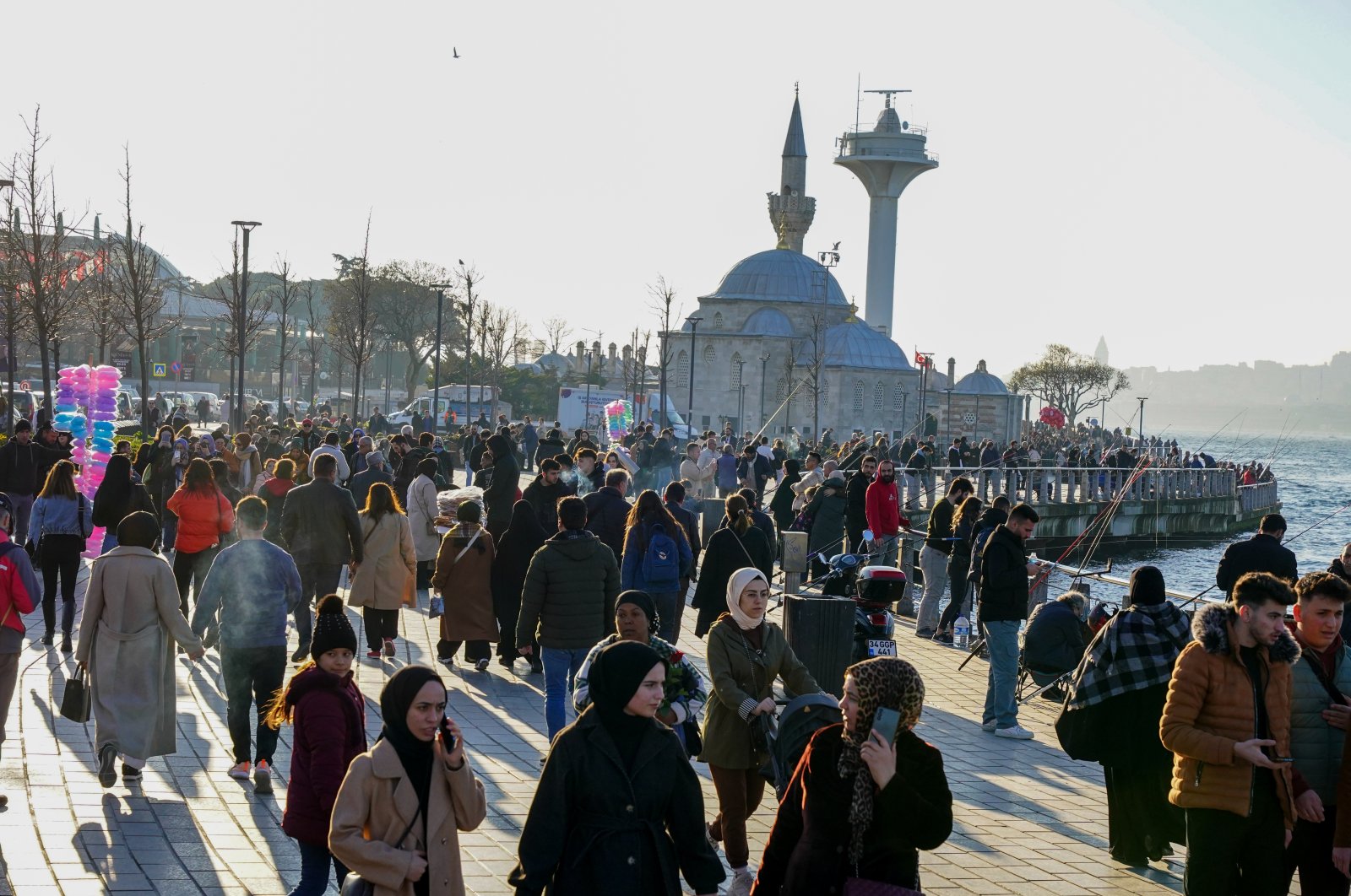 People walk along the Üsküdar coastline in Istanbul, Türkiye, Feb. 23, 2024. (Getty Images Photo)