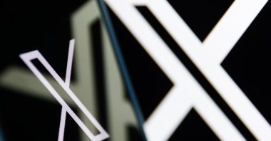 The X logo displayed on a phone screen and a laptop screen is seen in this illustration photo taken in Poland, July 24, 2024. (Reuters Photo)