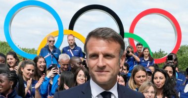 French President Emmanuel Macron looks on with the Olympic rings and French athletes behind him, Paris, U.S., July 22, 2024. (AFP Photo)