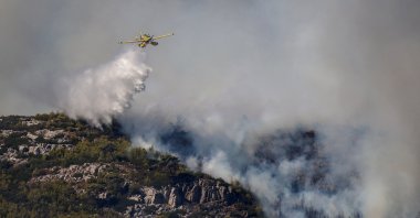 A firefighting plane makes a water drop as a wildfire burns in Grammatiko, near Athens, Greece, Aug. 12, 2024. (Reuters Photo)