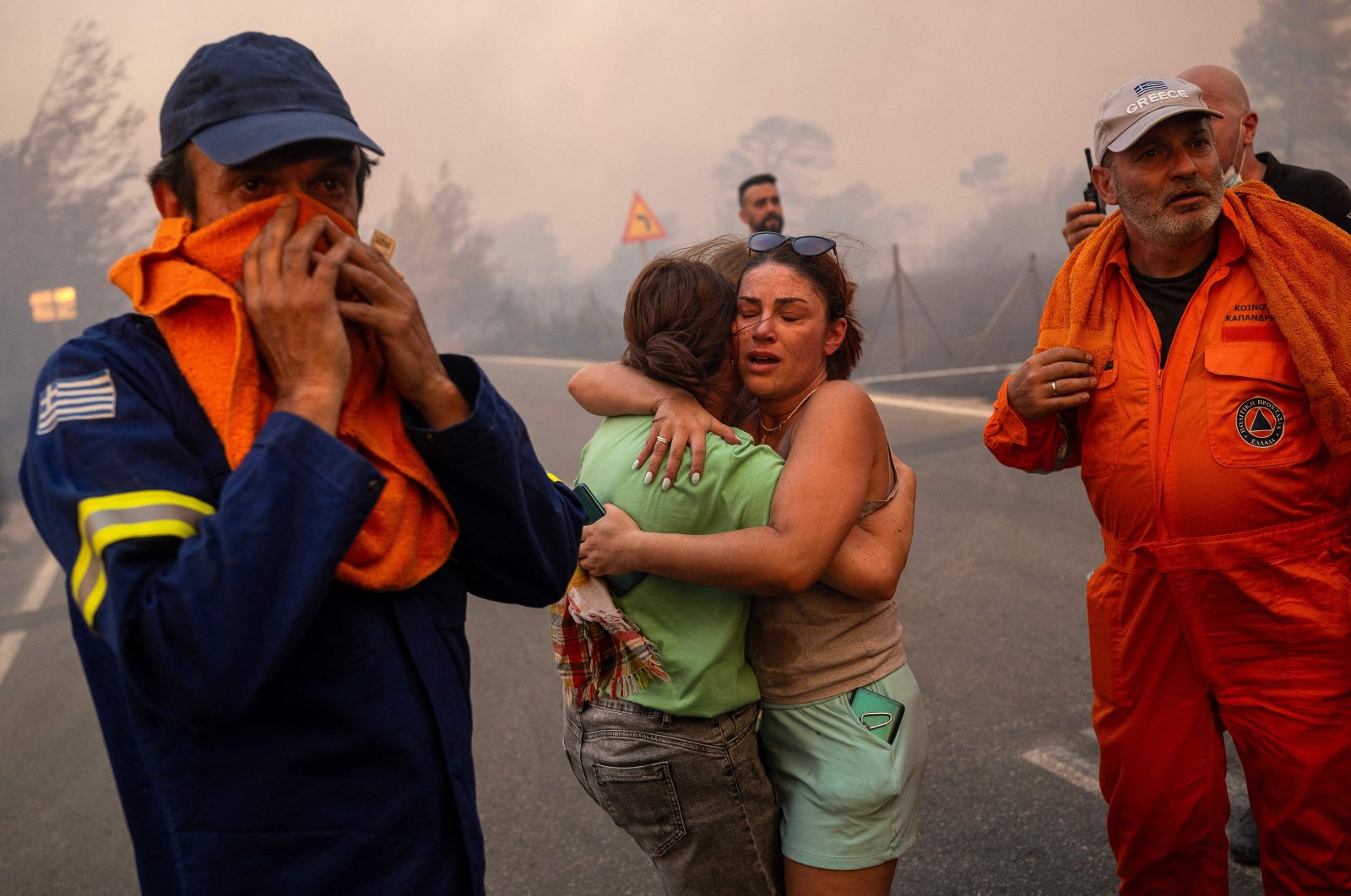 Women embrace after being rescued during a wildfire in Varnavas, north of Athens, Aug. 11, 2024. (AFP Photo)