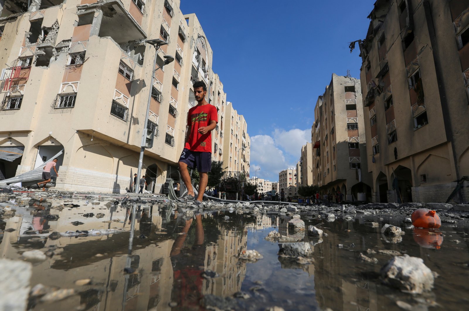 A Palestinian man walks past residential buildings hit by Israeli strikes in Khan Younis, southern Gaza Strip, Palestine, Aug. 11, 2024. (Reuters Photo)