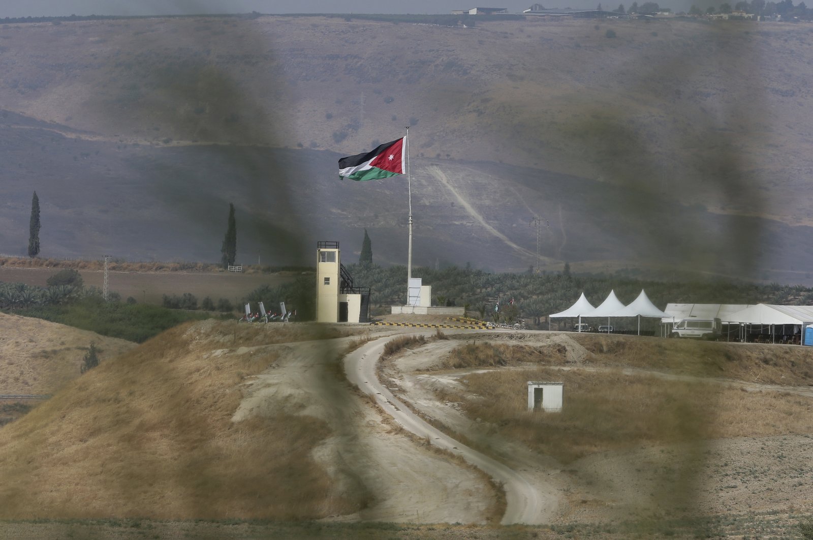 Soldiers stand guard in a watchtower flying Jordanian flags, in the area of ​​Baqoura near the Israeli-Jordanian, border, Wednesday, Nov. 13, 2019. (AP File Photo)