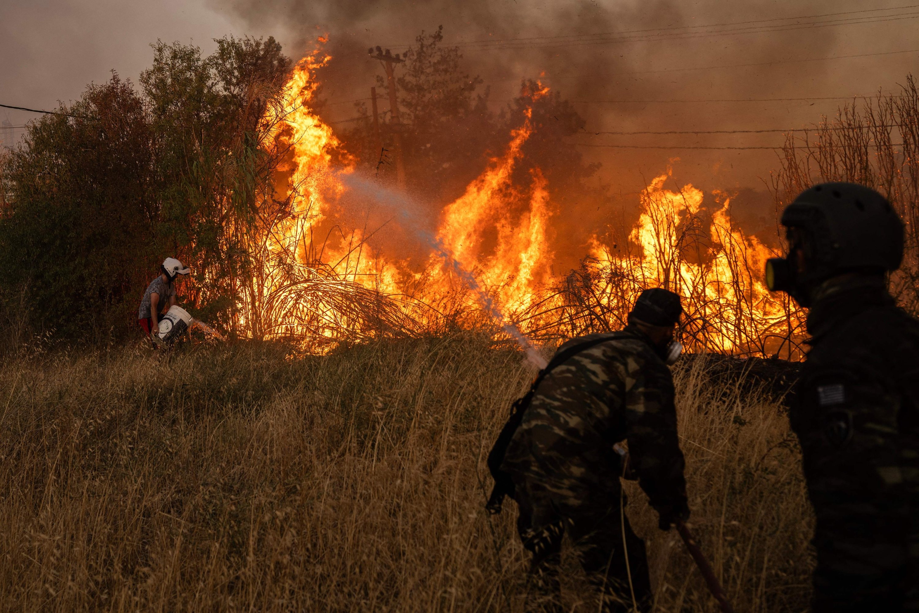 Volunteers try to extinguish a wildfire near Penteli, Greece, Aug. 12, 2024. (AFP Photo)