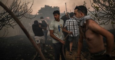 Volunteers try to extinguish a wildfire near Penteli, Greece, Aug. 12, 2024. (AFP Photo)