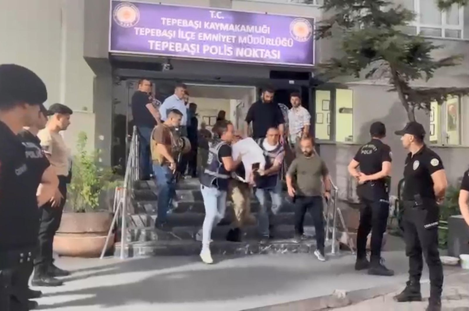 Police escort A.K. to the police station after detaining him in Eskişehir on Aug. 12, 2024. (DHA Photo)