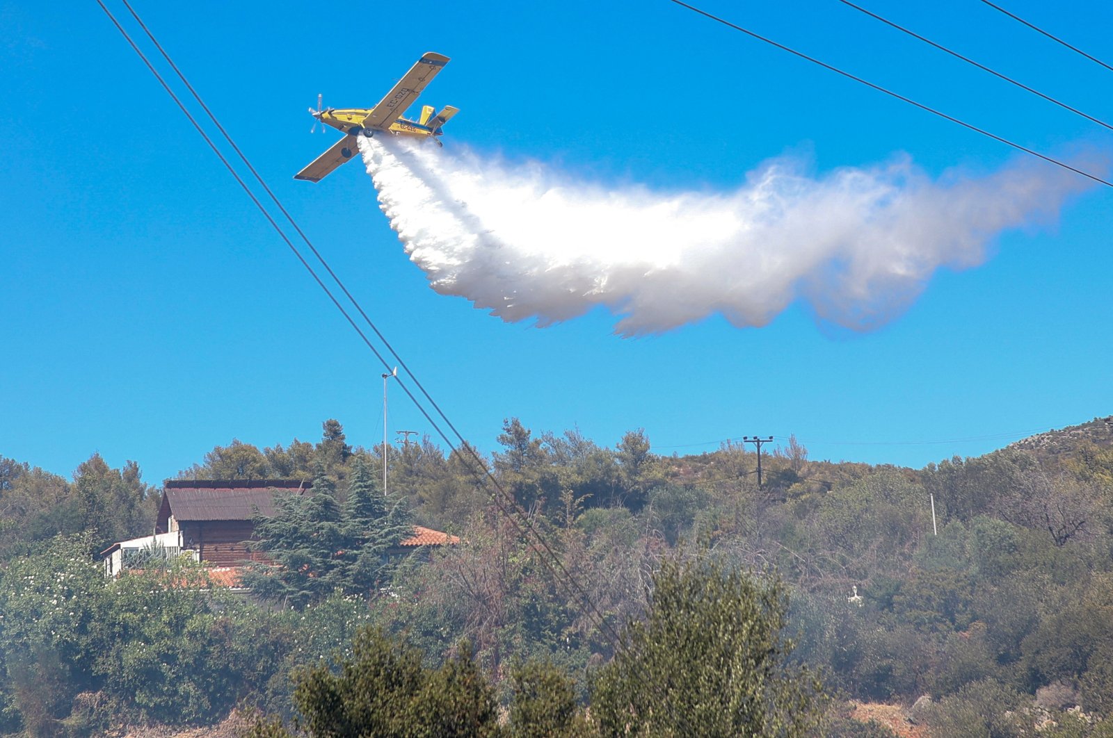 A Greek firefighting plane sprays water to extinguish a wildfire in the Ano Souli region in Attica, Greece, Aug. 12, 2024. (AFP Photo)