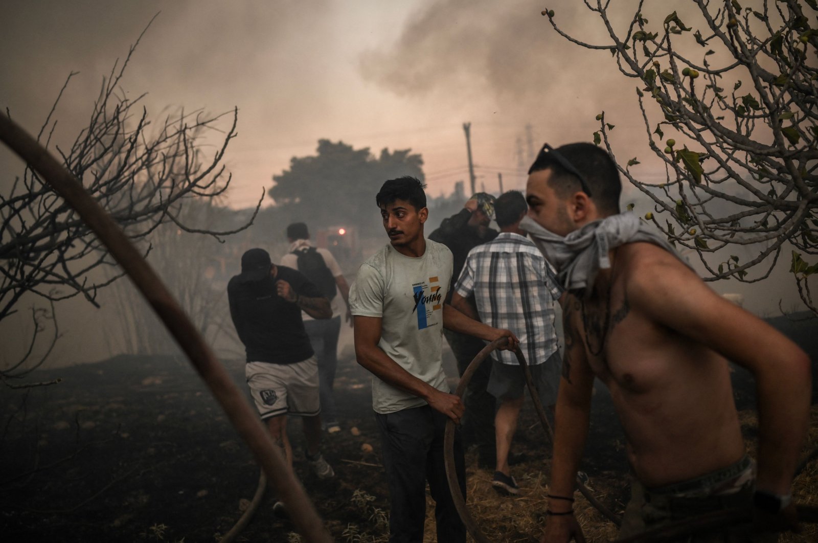 Volunteers try to extinguish a wildfire near Penteli, Greece, Aug. 12, 2024. (AFP Photo)