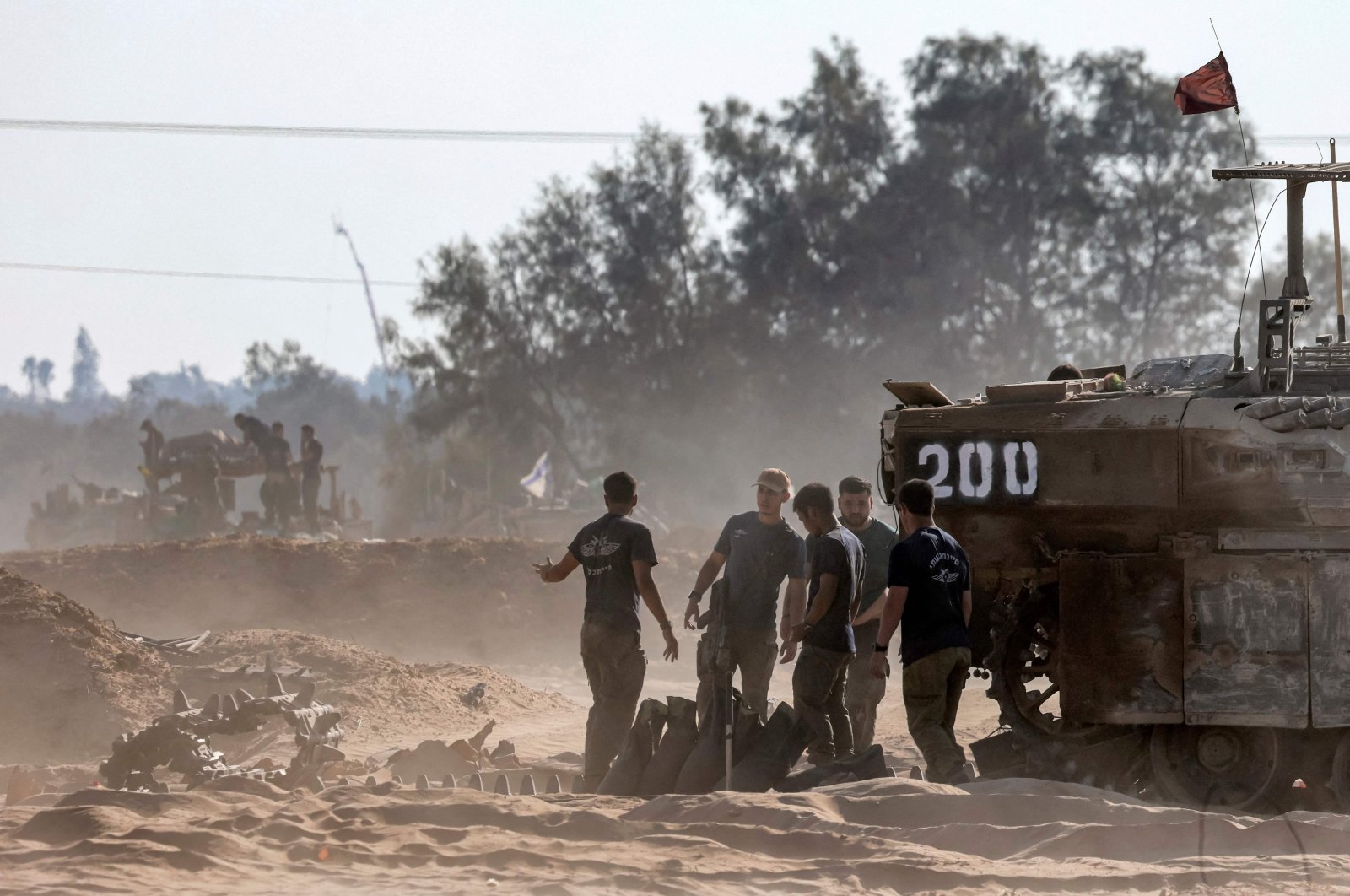 Israeli army soldiers repair the treads of a tracked vehicle at a position along the border with the Gaza Strip and southern Israel, July 14, 2024. (AFP File Photo)