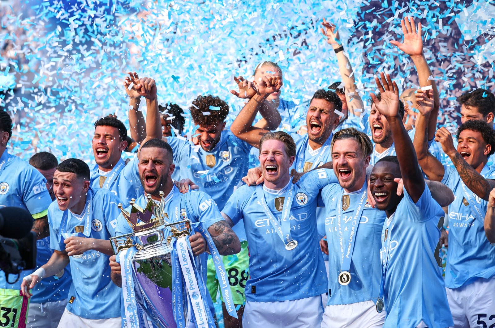 Manchester City players celebrate with the Premier League trophy after completing a record fourth consecutive title during the Premier League match against West Ham United at Etihad Stadium, Manchester, U.K., May 19, 2024. (Getty Images Photo)