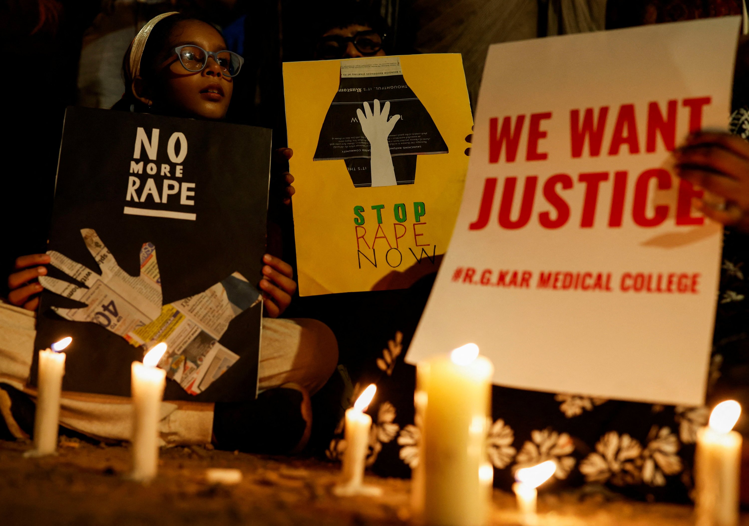 People hold posters during a vigil condemning the rape and murder of a medic in Kolkata, on a street in Mumbai, India, Aug. 14, 2024. (Reuters Photo)