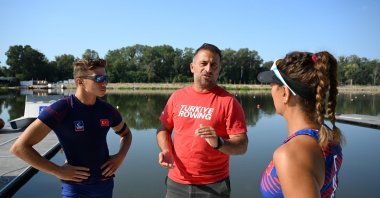 Turkish rowing national team Coach Orkun Pelvan (C) instructs rowers Yiğit Doğukan Bozkurt (L) and Nurşen Şen at the Meriç River, Edirne, Türkiye, Aug. 3, 2024. (AA Photo)