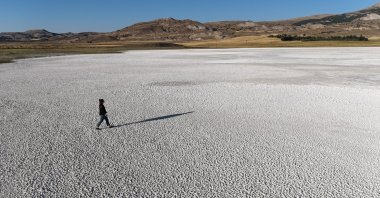 A local walks on the dried-up surface of Kellah Lake, Sivas, Türkiye, Aug. 15, 2024. (IHA Photo)