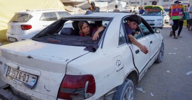 Children sit inside a damaged car in Khan Younis, southern Gaza Strip, Palestine, Aug. 15, 2024. (AFP Photo)