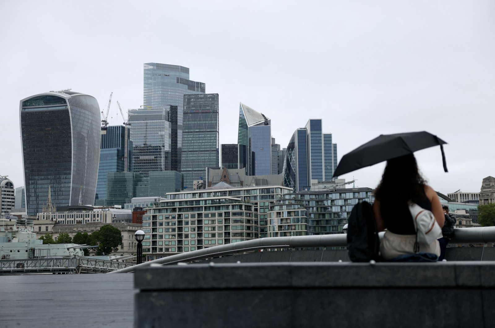 A woman holds an umbrella while looking at the city&#039;s skyline, London, U.K., July 25, 2024. (Reuters Photo)