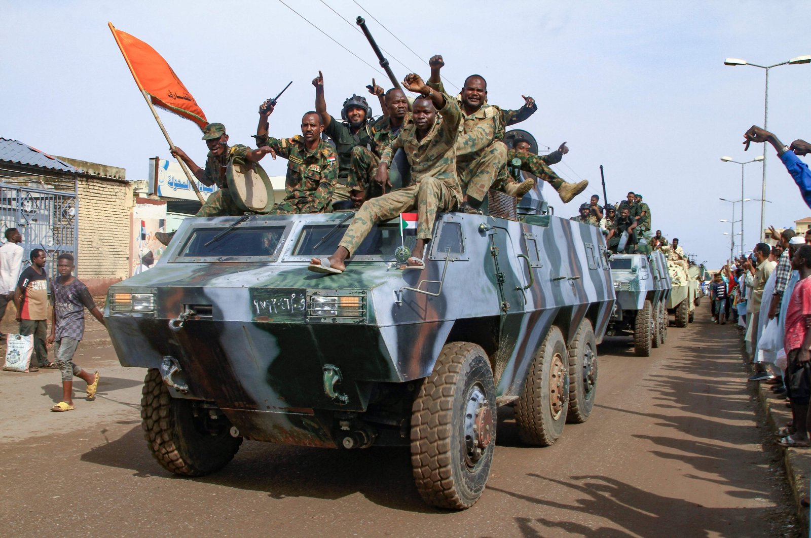 People cheer members of Sudan's armed forces taking part in a military parade held on Army Day in Gadaref on August 14, 2024. (Photo by AFP)