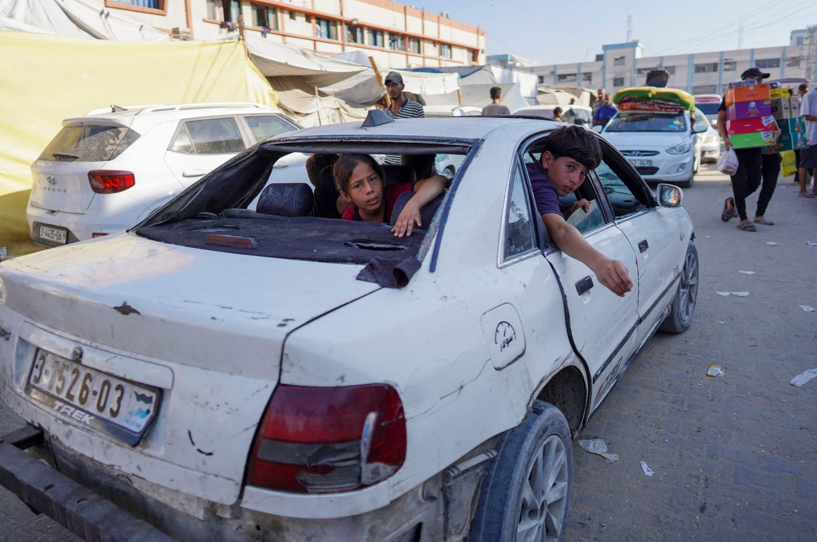 Children sit inside a damaged car in Khan Younis, southern Gaza Strip, Palestine, Aug. 15, 2024. (AFP Photo)