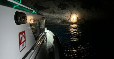 Turkish coast guard vessel approach a rubber boat of 30 migrants stranded on a shore after being pushed back by Greece, western Muğla province, Türkiye, Aug. 15, 2024. (AA Photo)