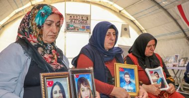 &quot;Diyarbakır Mothers&quot; hold photographs of their children abducted by PKK terrorists during a sit-in protest, Diyarbakır, southeastern Türkiye, Aug. 16, 2024. (AA Photo)