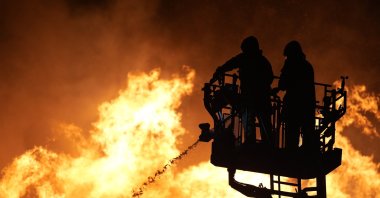 Firefighters try to extinguish a fire in the Yamanlar neighborhood in Izmir&amp;#039;s Karşıyaka district, Aug. 16, 2024. (AA Photo)