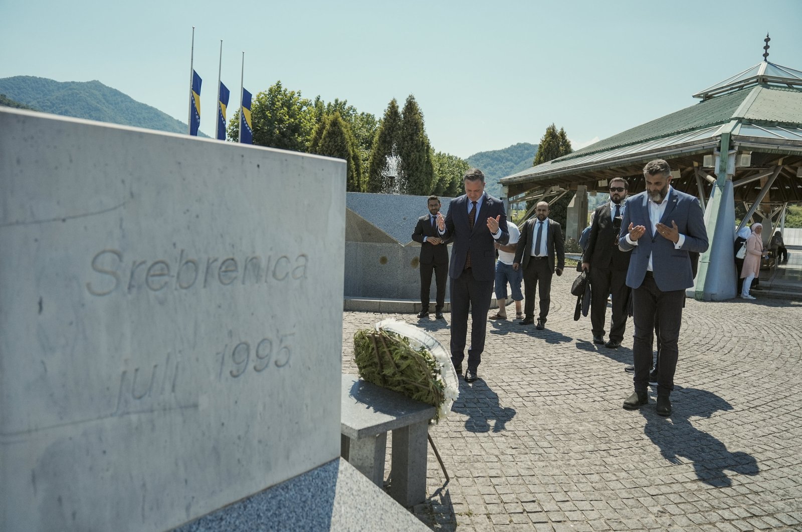 Turkish Cooperation and Coordination Agency (TIKA) President Serkan Kayalar (L) and other officials pray during a visit to the graves of the martyrs in Srebrenica, Bosnia-Herzegovina, Aug. 16, 2024. (AA Photo)