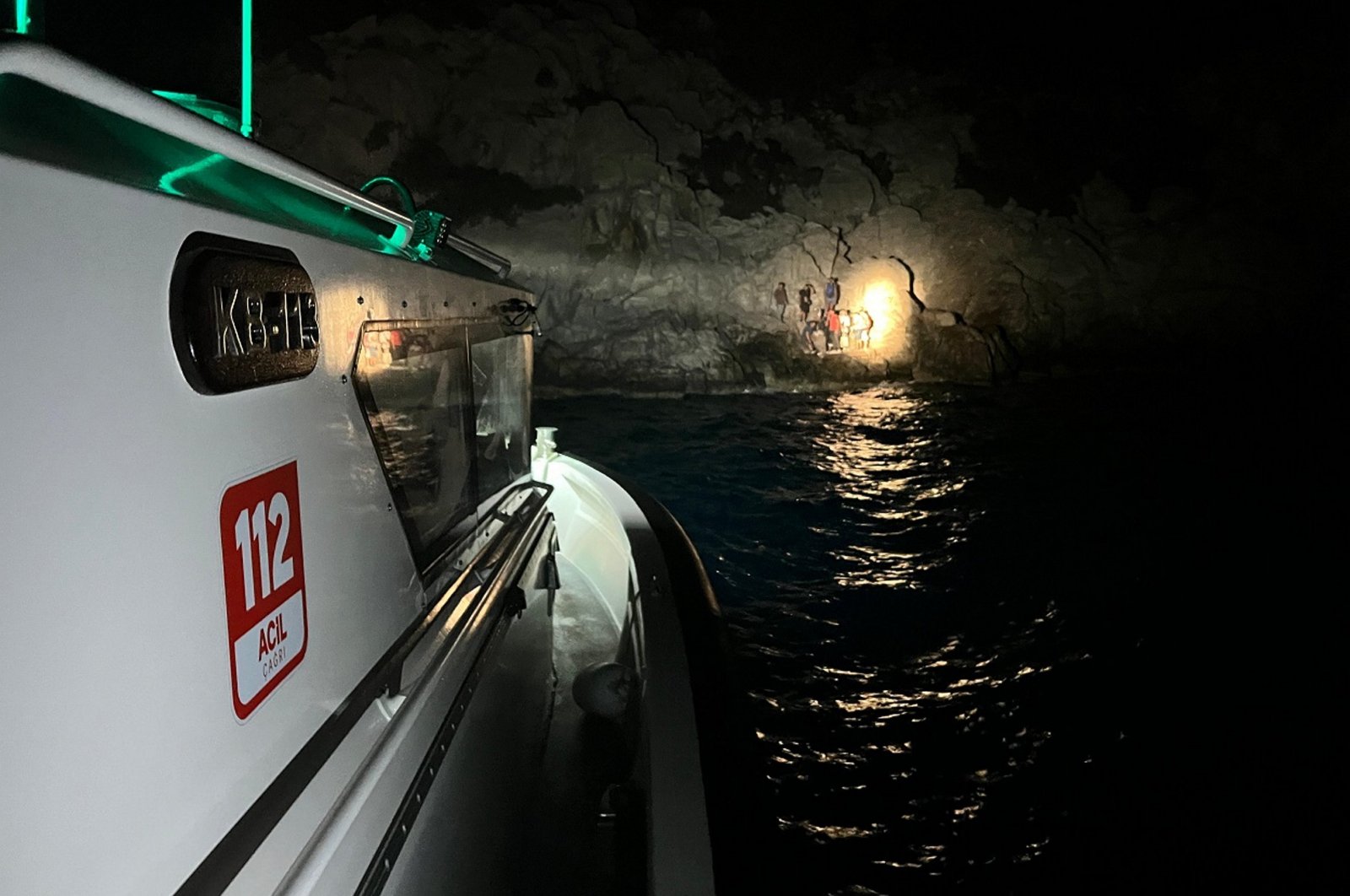 Turkish coast guard vessel approach a rubber boat of 30 migrants stranded on a shore after being pushed back by Greece, western Muğla province, Türkiye, Aug. 15, 2024. (AA Photo)