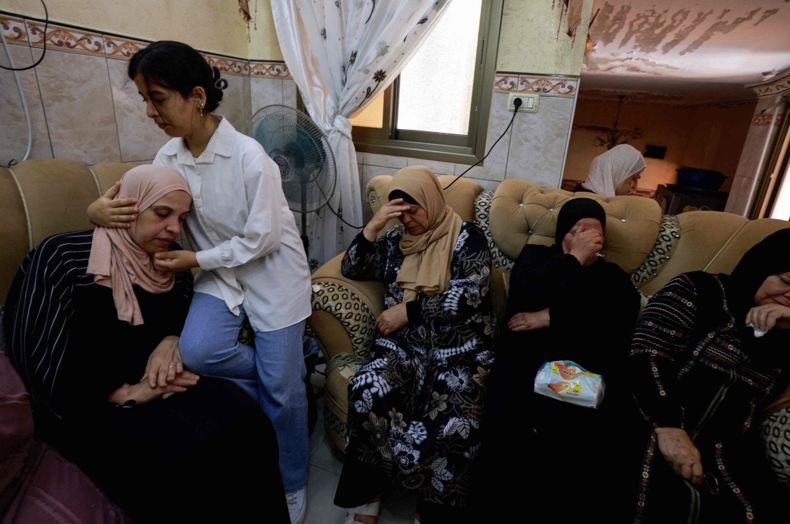 A young girl comforts the mother of a 23-year-old Palestinian man, a day after he was killed during an attack by Jewish settlers on the village of Jit near Nablus, occupied West Bank, Palestine, Aug. 16, 2024. (AFP Photo)