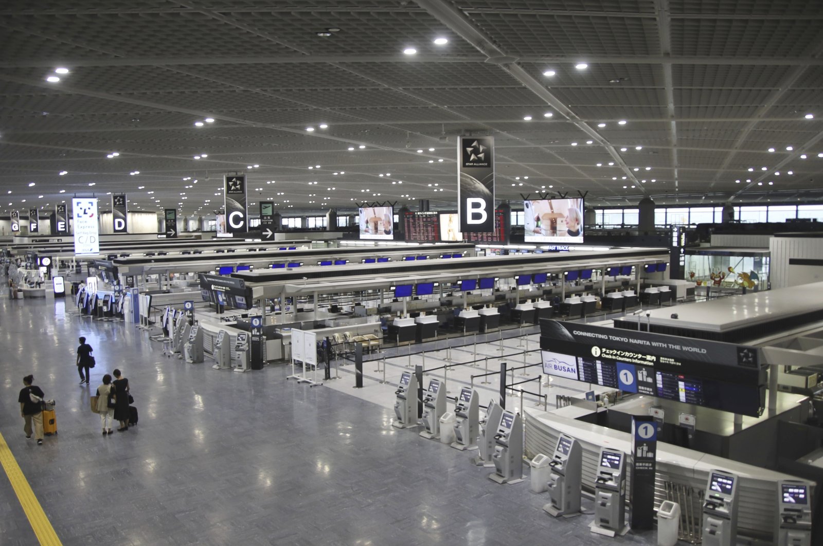 Only a few people are seen at a terminal of Narita International Airport as flights were canceled due to Typhoon Ampil, Narita, Tokyo, Aug. 16, 2024. (AP Photo)