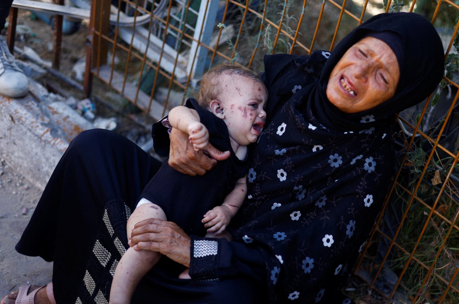 Reem Abu Haya, a Palestinian girl who survived an Israeli strike that killed her entire family, cries as she is held by a relative at Nasser Hospital, in Khan Younis in the southern Gaza Strip, Aug. 13, 2024. (Reuters Photo)