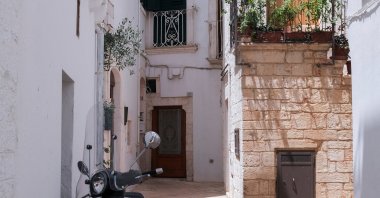 A Vespa scooter is parked in a street of Locorotondo, near Bari, in the southern region of Puglia, Italy, June 30, 2024. (Reuters Photo)