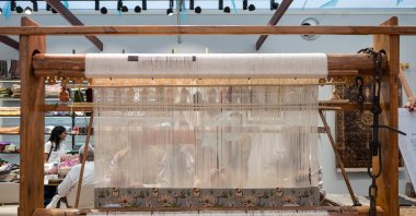 People work on a weaving loom at the India House at Nations Park in Paris, France, July 30, 2024. (AFP Photo)