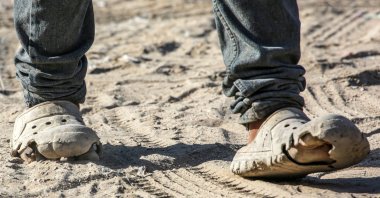 A Palestinian walks in damaged shoes in Khan Younis, southern Gaza Strip, July 6, 2024. (AFP Photo)