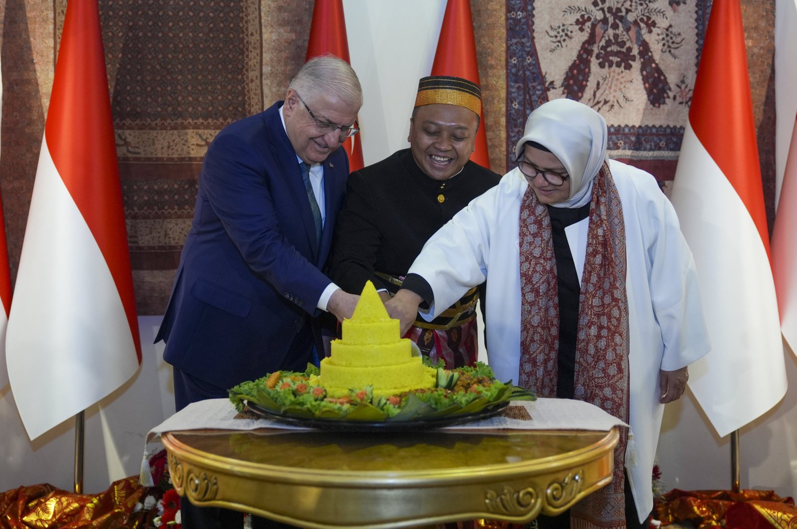 Defense Minister Yaşar Güler (L), Indonesia’s Ambassador to Ankara Achmad Rizal Purnama (C) and Justice and Development Party (AK Party) Kayseri deputy Ayşe Böhürler (L) are seen at a reception at the Indonesian Embassy, Ankara, Türkiye, Aug.17, 2024. (AA Photo).