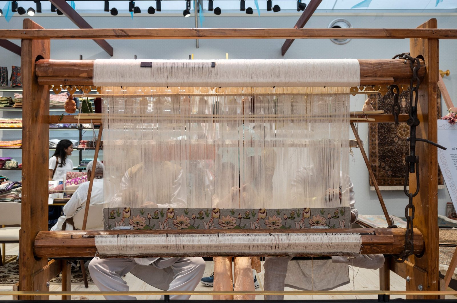 People work on a weaving loom at the India House at Nations Park in Paris, France, July 30, 2024. (AFP Photo)