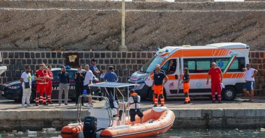 Italian Carabinieri and health workers wait on the quay as the coast guard searches for six missing people after a sailboat sank off Porticello, Sicily, Aug. 19, 2024. (AFP Photo)