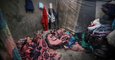 Displaced Palestinians sleep in a tent on the first day of the Eid al-Fitr festival, marking the end of the holy month of Ramadan, at a camp beside a street in Rafah, southern Gaza Strip,  April 10, 2024. (AFP File Photo)