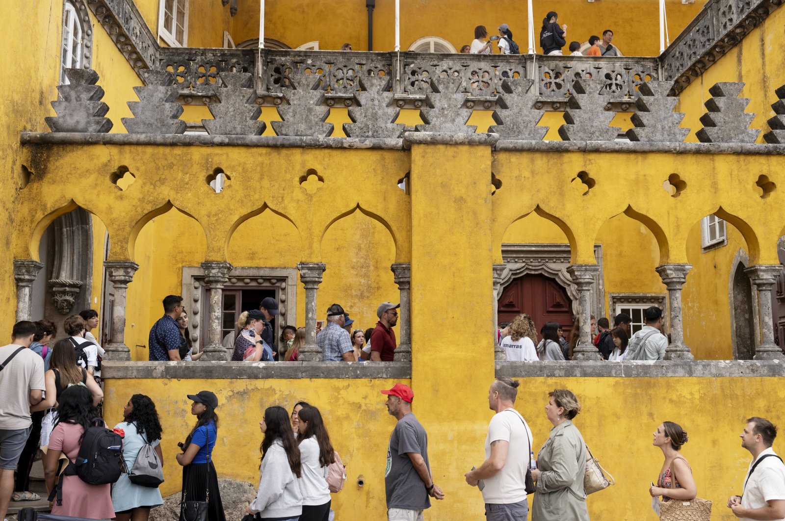 Tourists line up to visit the interior of the 19th-century Pena Palace, Sintra, Portugal, Aug. 14, 2024. (AP Photo)