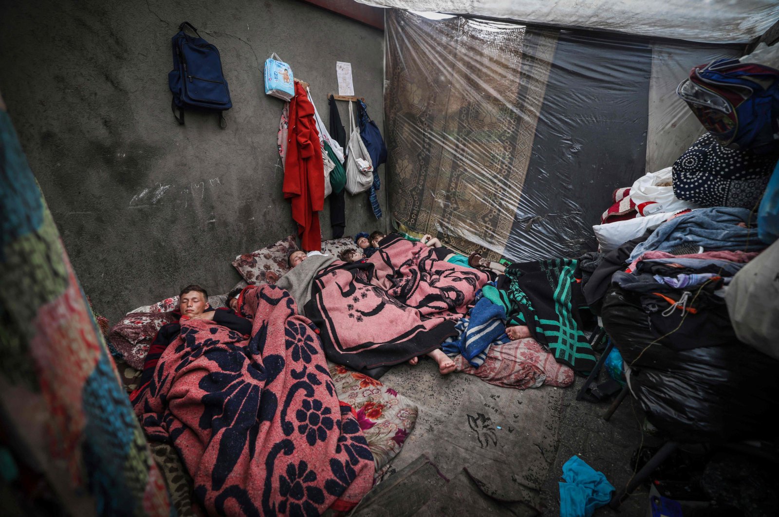 Displaced Palestinians sleep in a tent on the first day of the Eid al-Fitr festival, marking the end of the holy month of Ramadan, at a camp beside a street in Rafah, southern Gaza Strip,  April 10, 2024. (AFP File Photo)