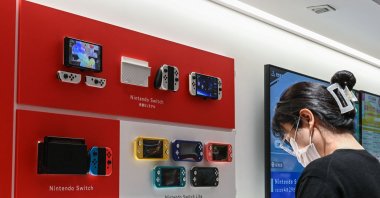 A woman looks at a Nintendo Switch display at a Nintendo store in central Tokyo, Japan, Nov. 6, 2023. (AFP File Photo)